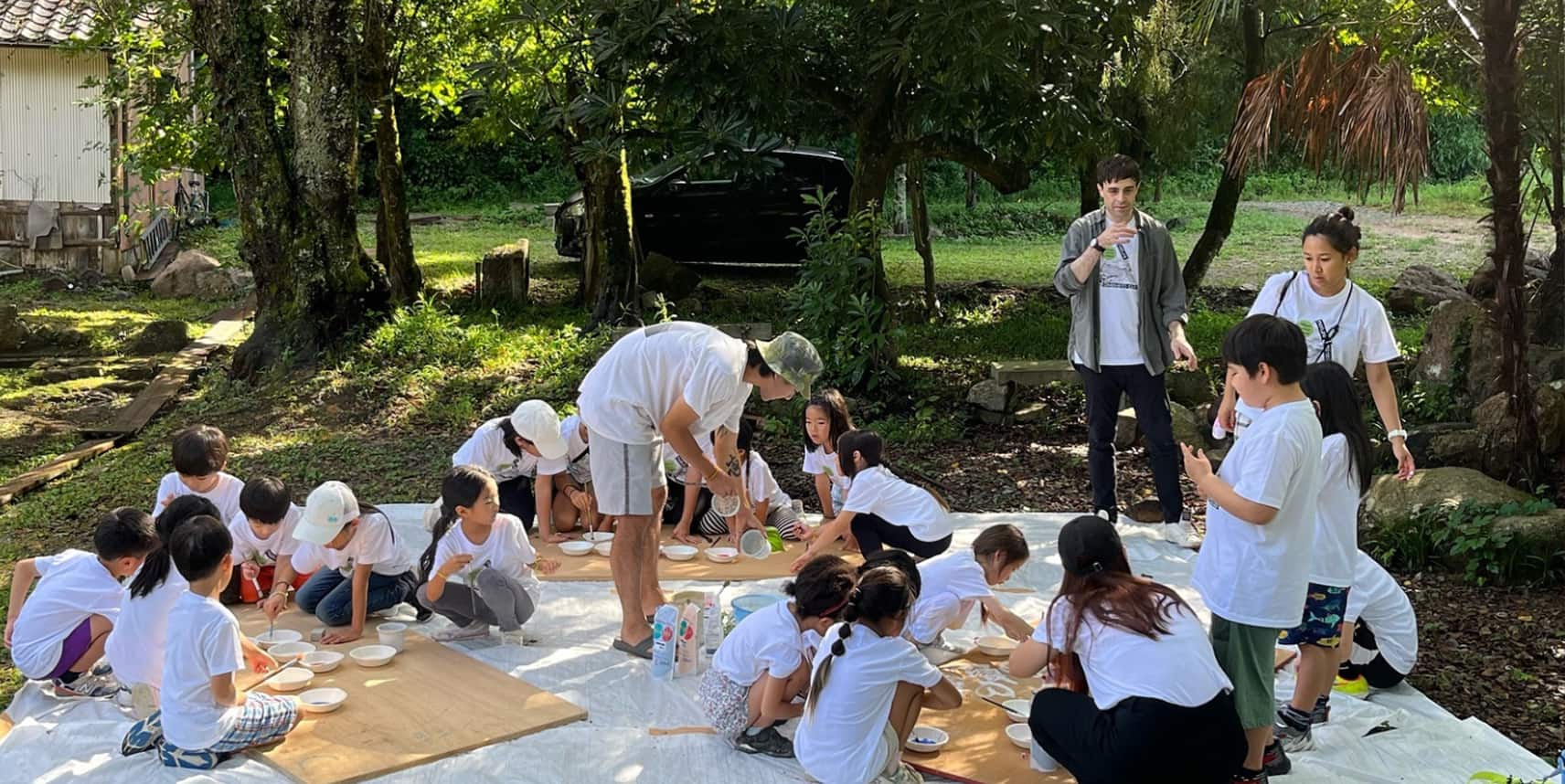 Teachers working on art outside with students