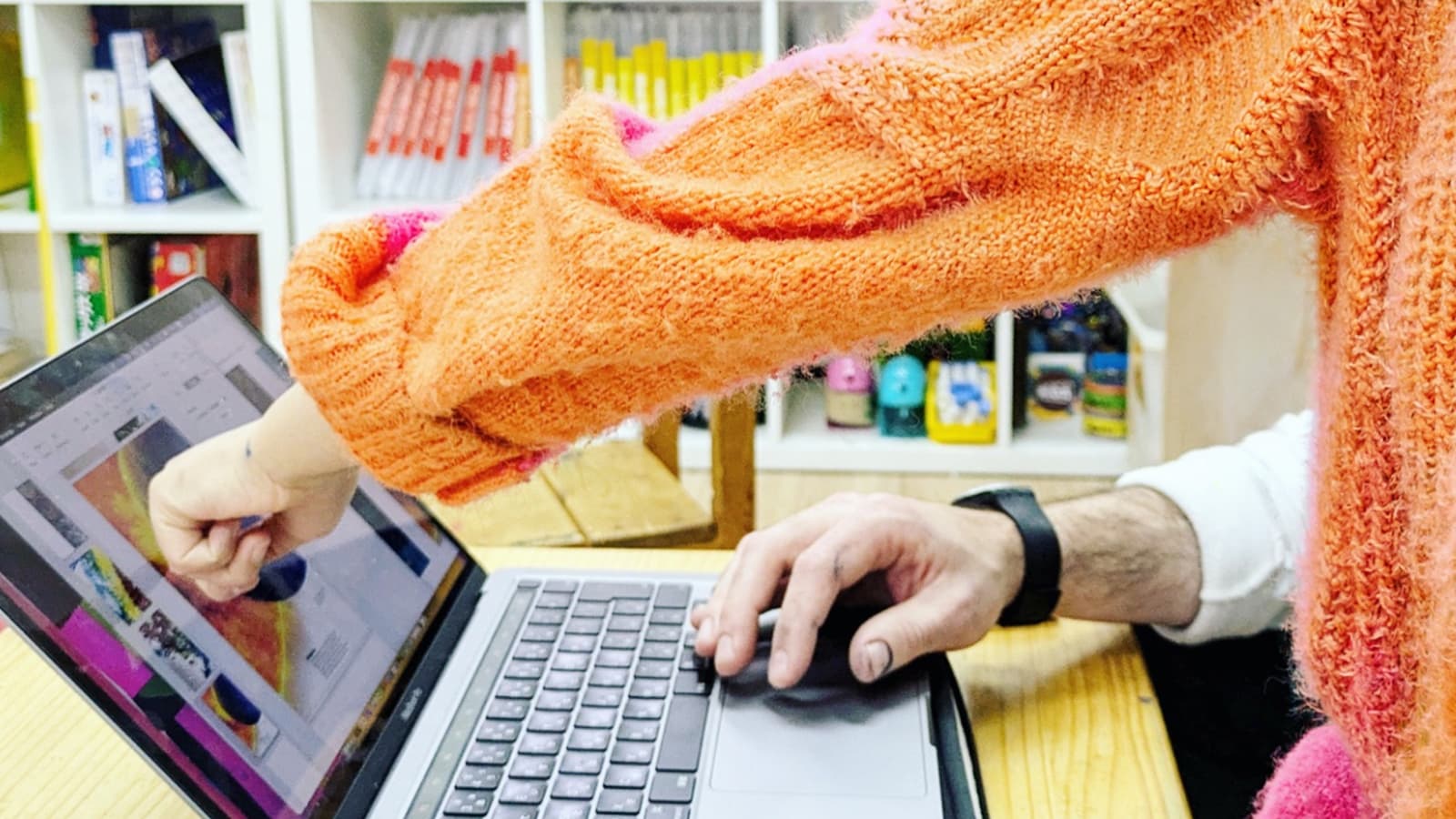 Student working with teacher on laptop to research
